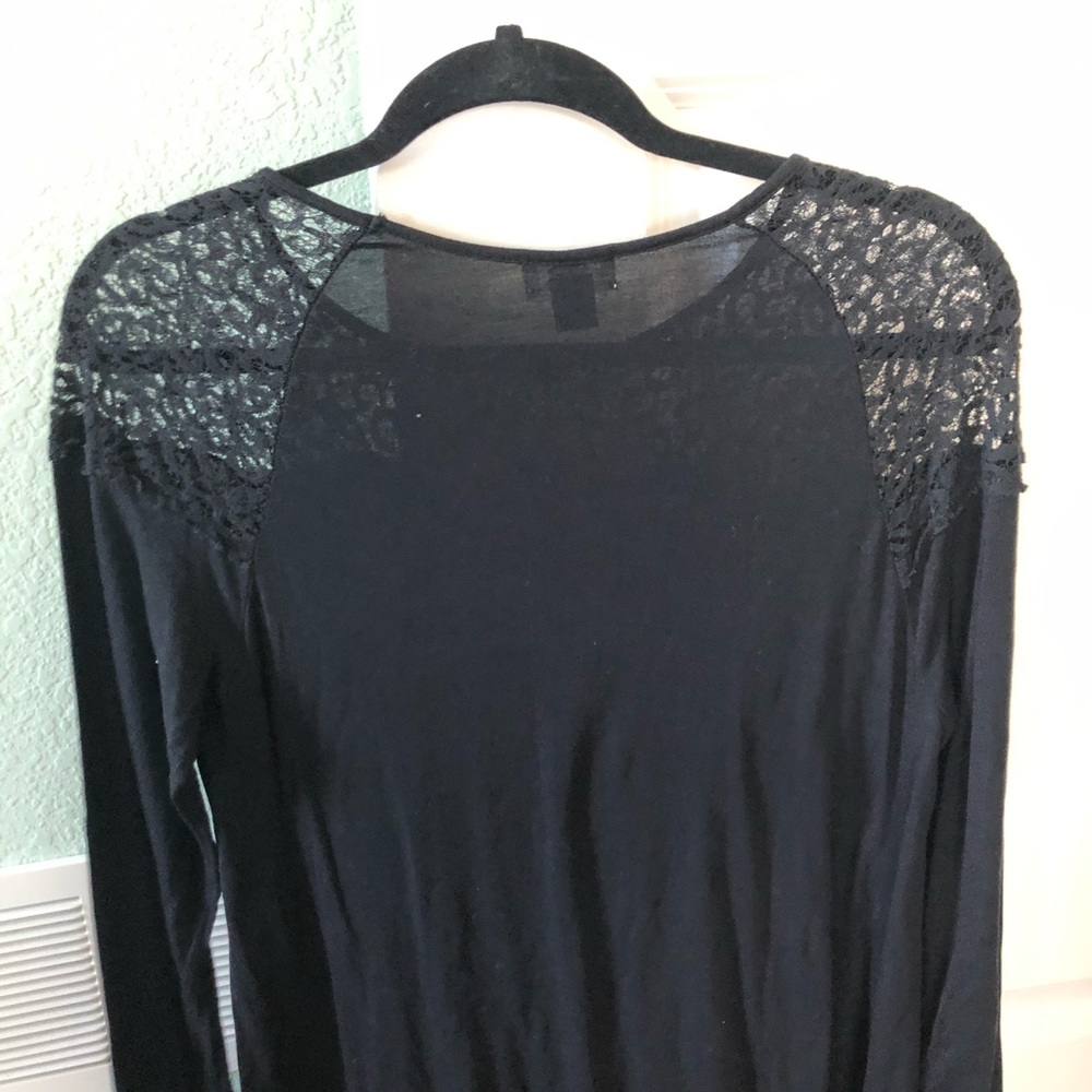 Woman’s black long sleeved top with lace detail